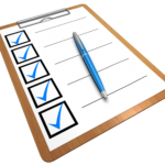 A clipboard with a checklist featuring several checked boxes and a blue pen on top.